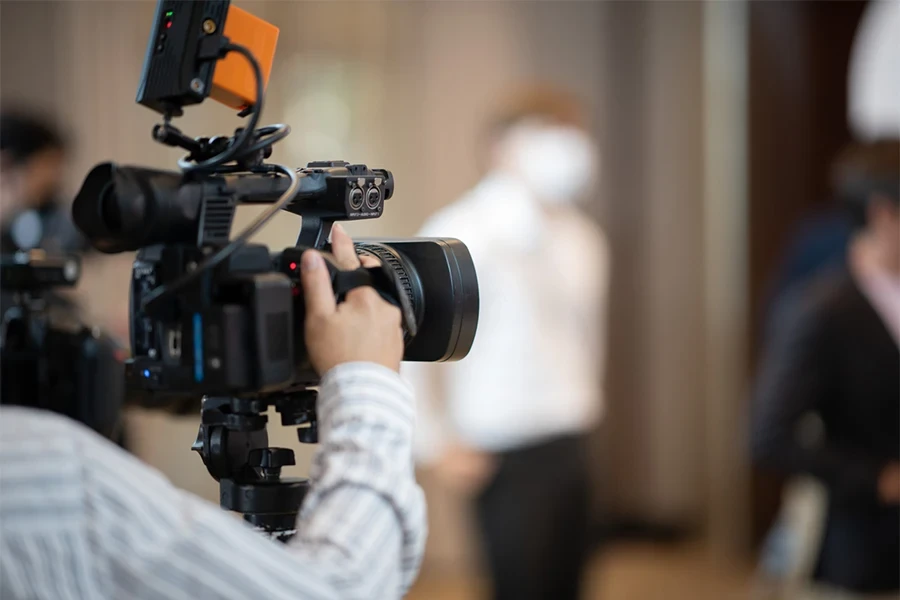 a man filming with a video camera