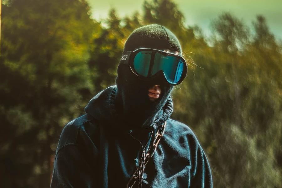 a man in a black balaclava and ski goggles