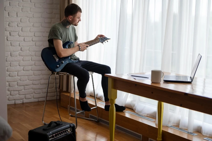 a man playing a smart guitar