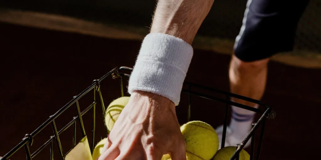 a man reaching into a basket wearing a sports wristband