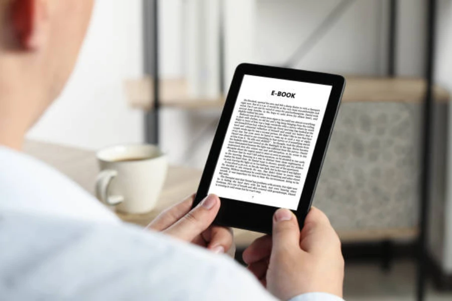 A man reading an ebook on an e-reader with a simple design