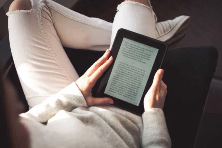 A man reading with an e-reader that has optimal battery life