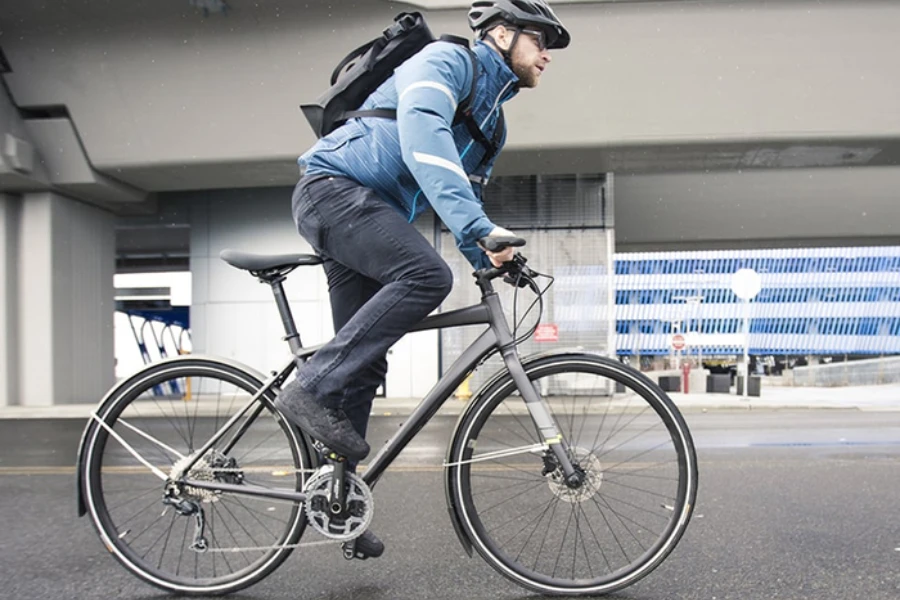 a man riding a hybrid bike on the urban street