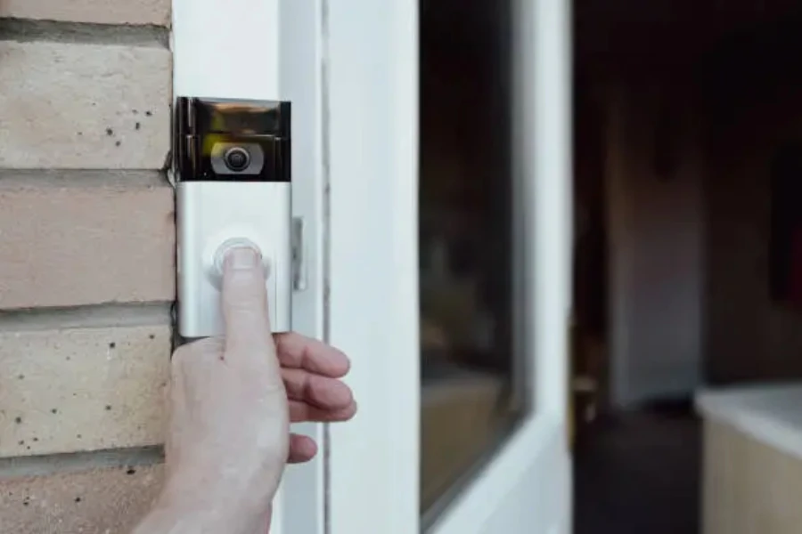 A man ringing a smart doorbell