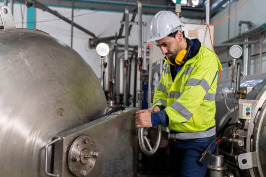 A mechanic checking a steam boiler