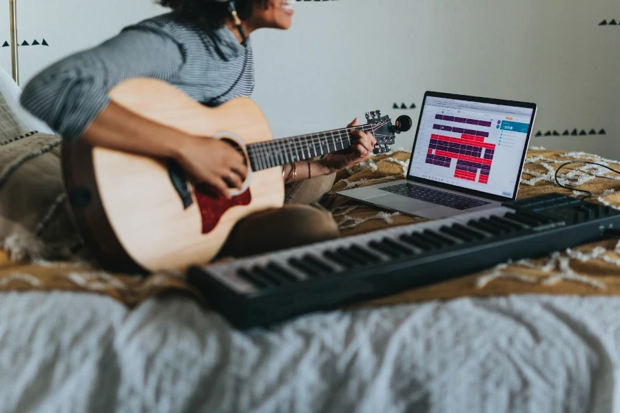 a musician making music with a guitar at home