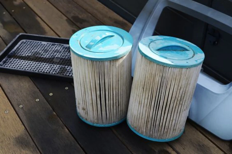 A pair of hot tub skimmers with blue lids