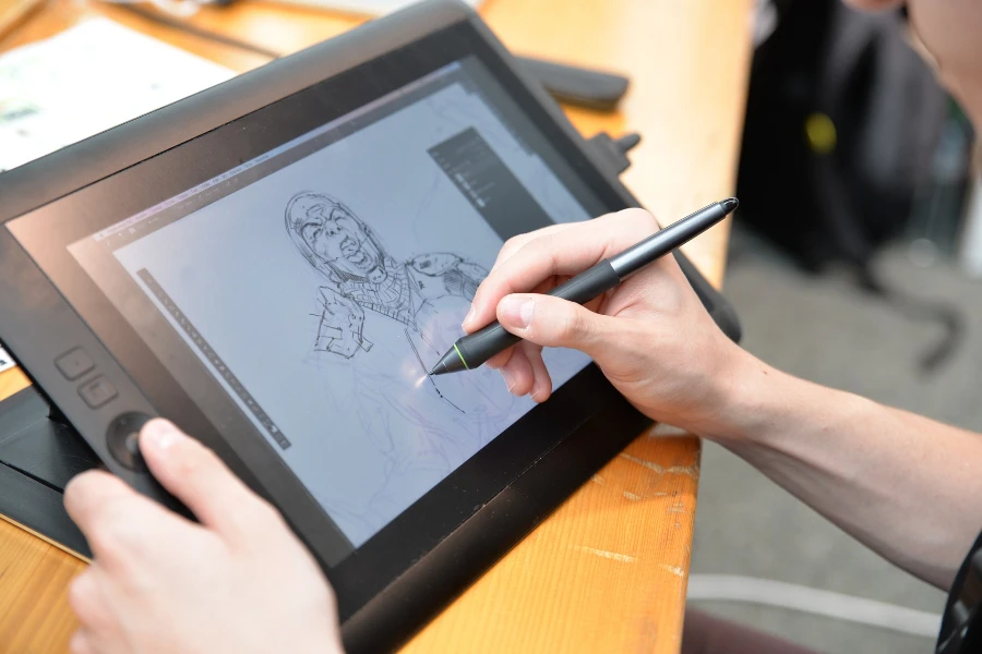 A person drawing on an LCD writing tablet