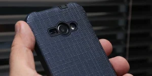 a person holding a blue-cased smartphone