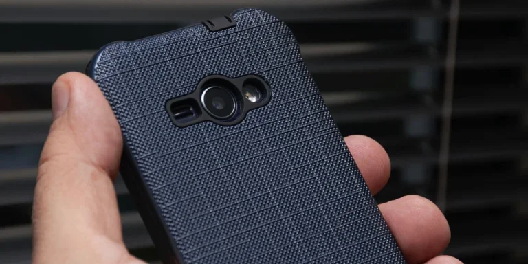 a person holding a blue-cased smartphone