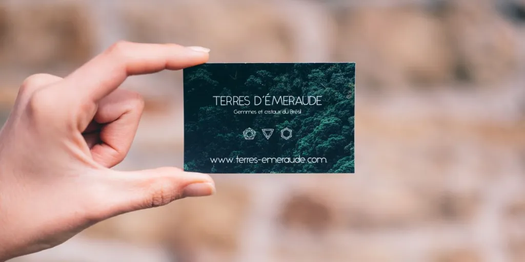 A person holding a business card
