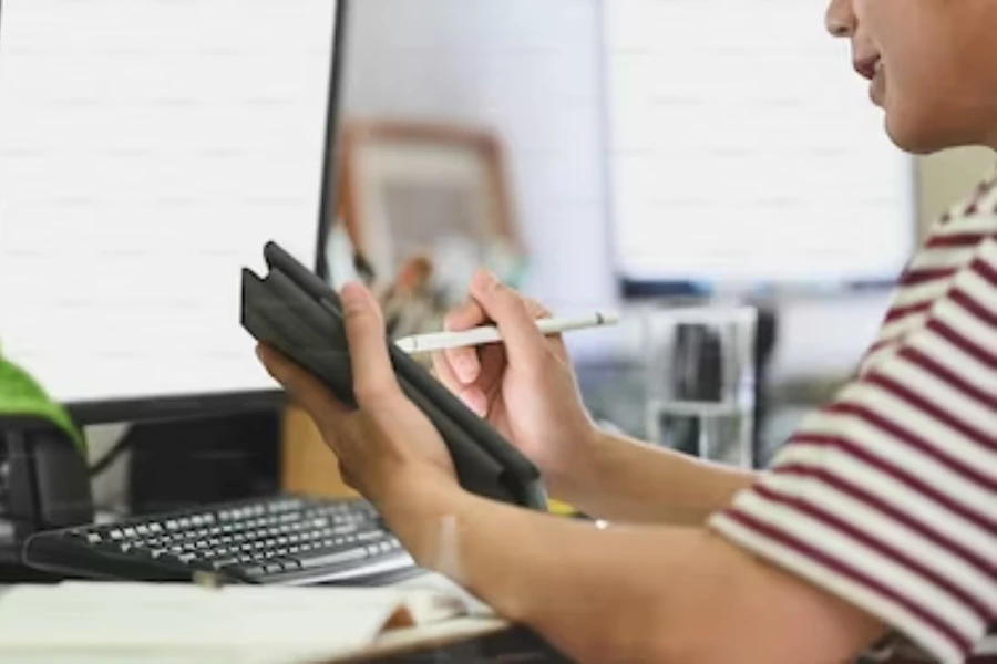 A person using a compact drawing tablet