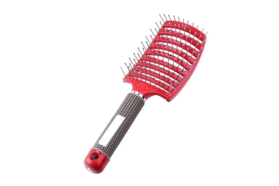 a pink wig brush on a white background