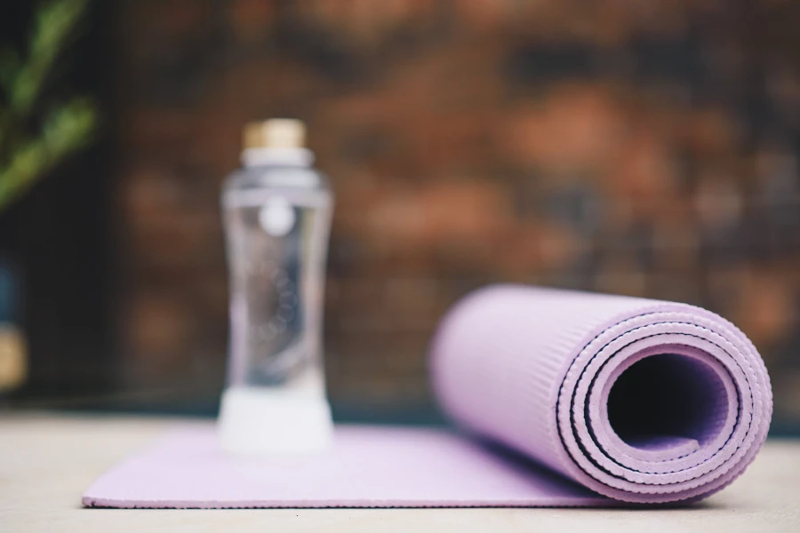 a purple rolled-up yoga mat