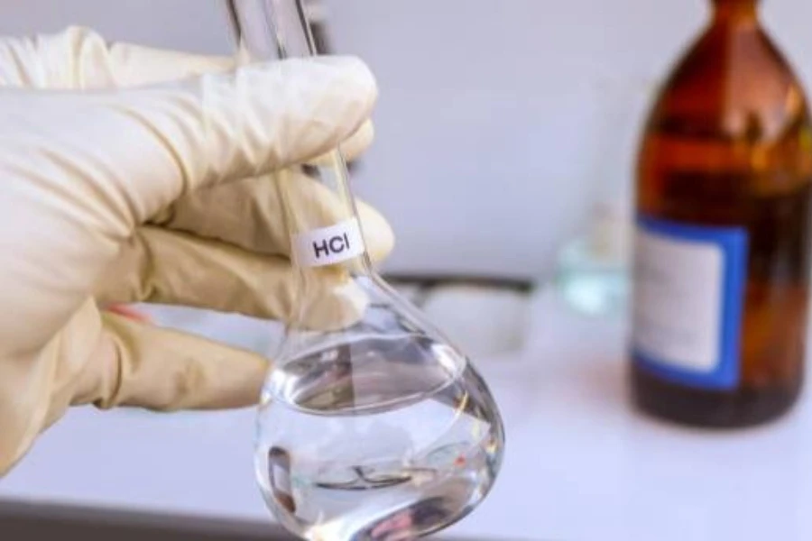 a scientist holding a flask of hydrochloric acid