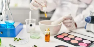a scientist making makeup with biotech ingredients