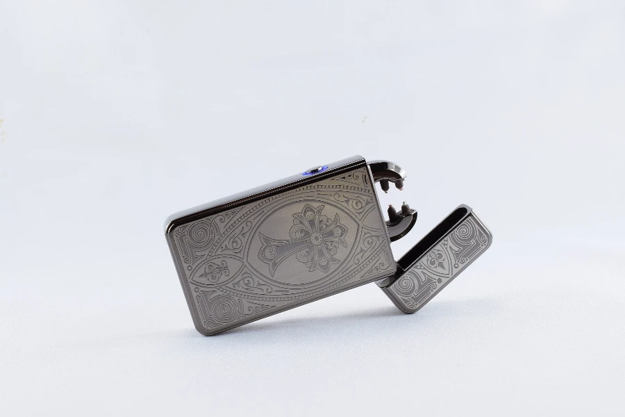 a silver electric lighter with stylish engravings
