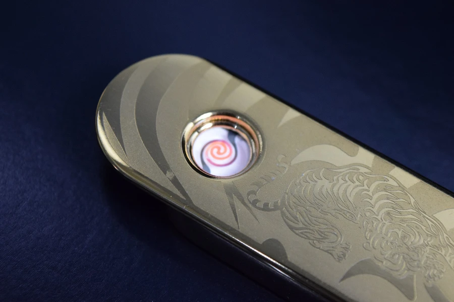 a silver flameless lighter with tiger engravings