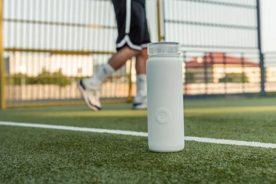 a white filtered sports water bottle placed on a pitch