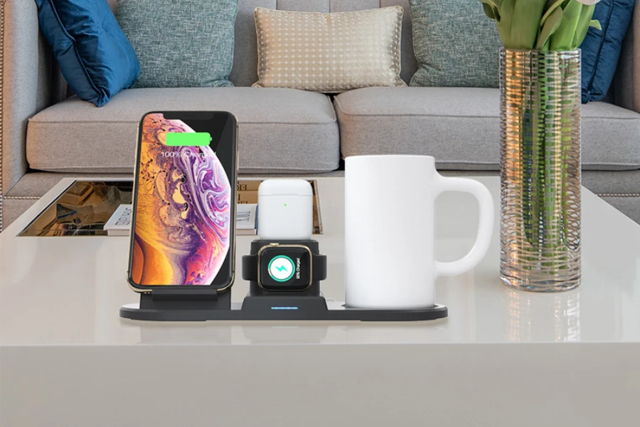 a wireless charger with phone, wristwatch and mug