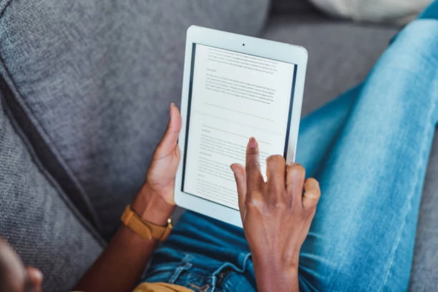 A woman scrolling through a document on an e-reader