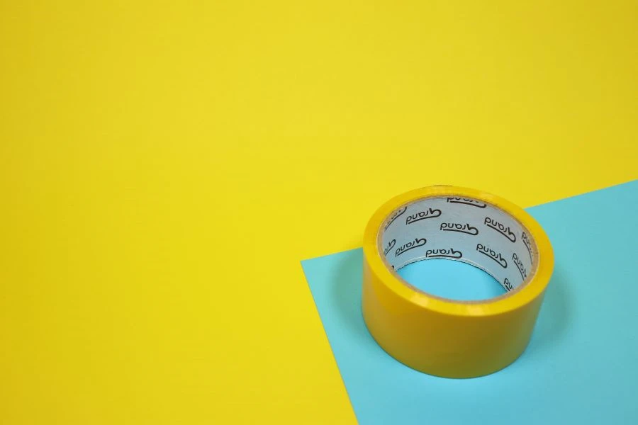 A yellow duct tape on a blue surface