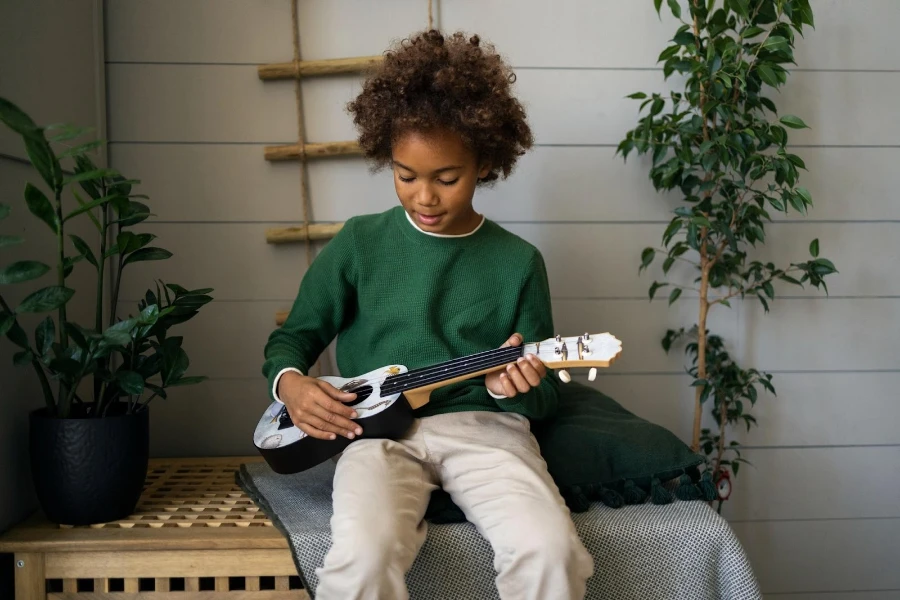 a young kid playing a guitar