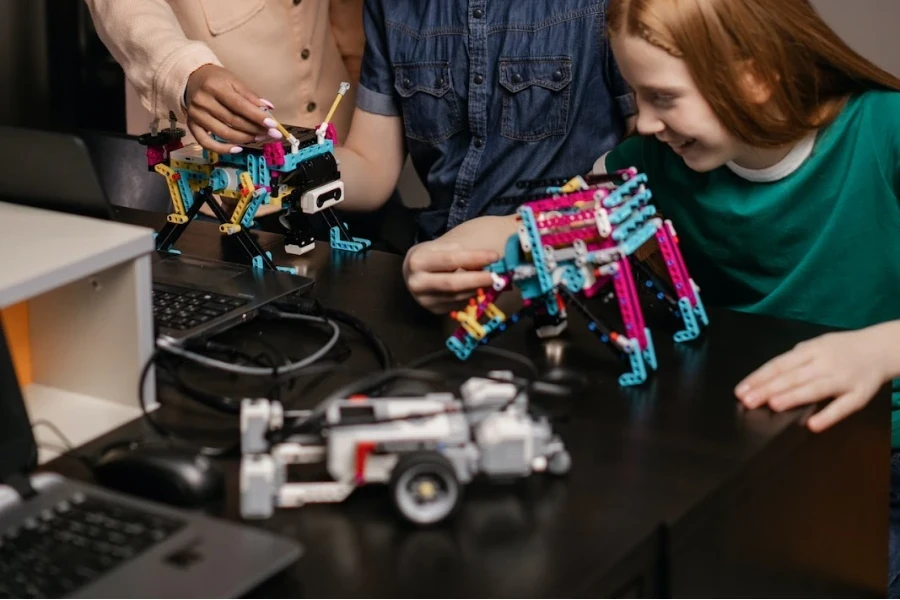 Adult and youngsters playing with programmable building blocks