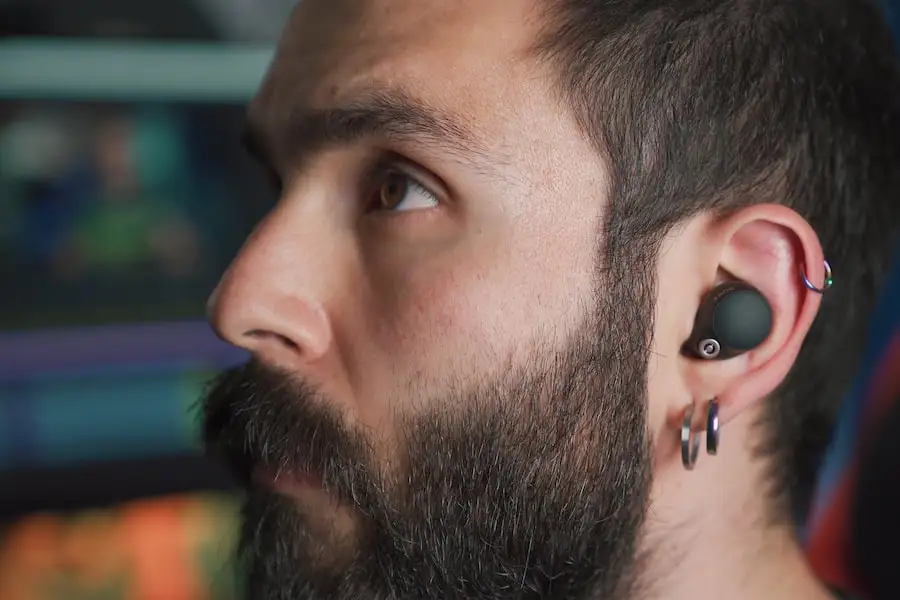 bearded man wearing wireless earphones