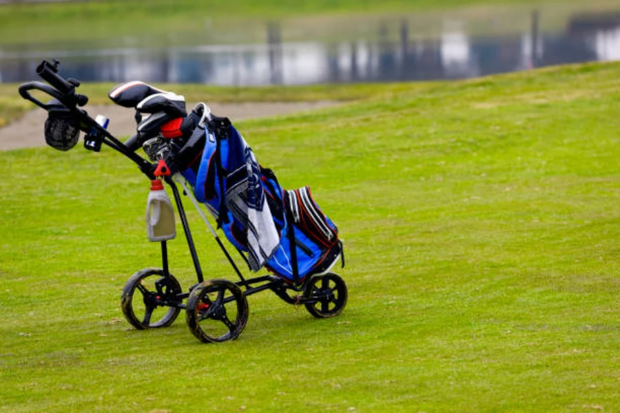 Black golf trolley holding a blue golf bag with clubs