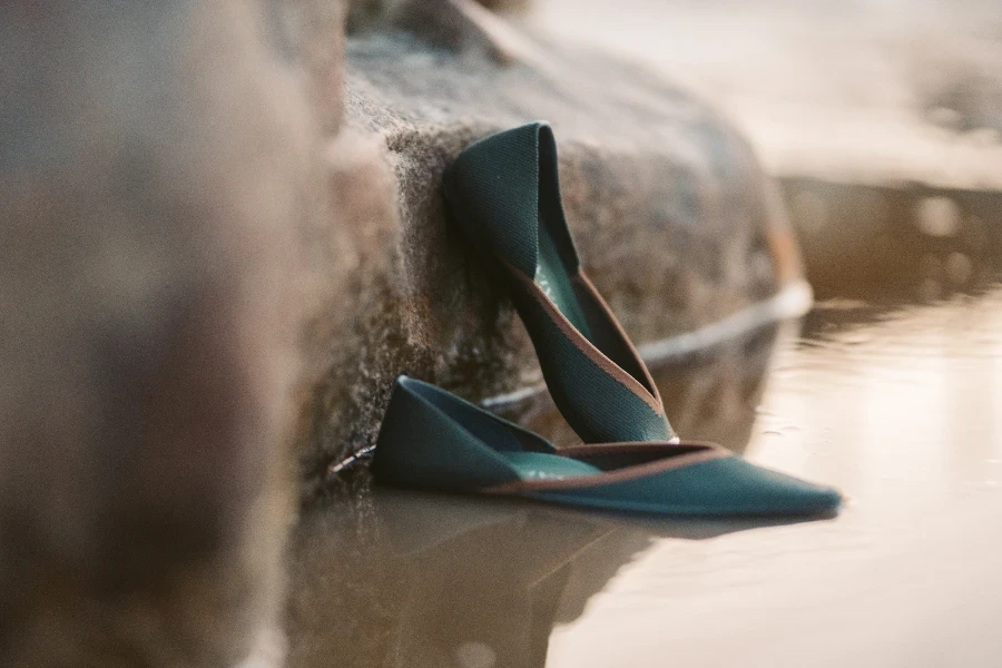 Blue slip-on water shoes resting on a stone