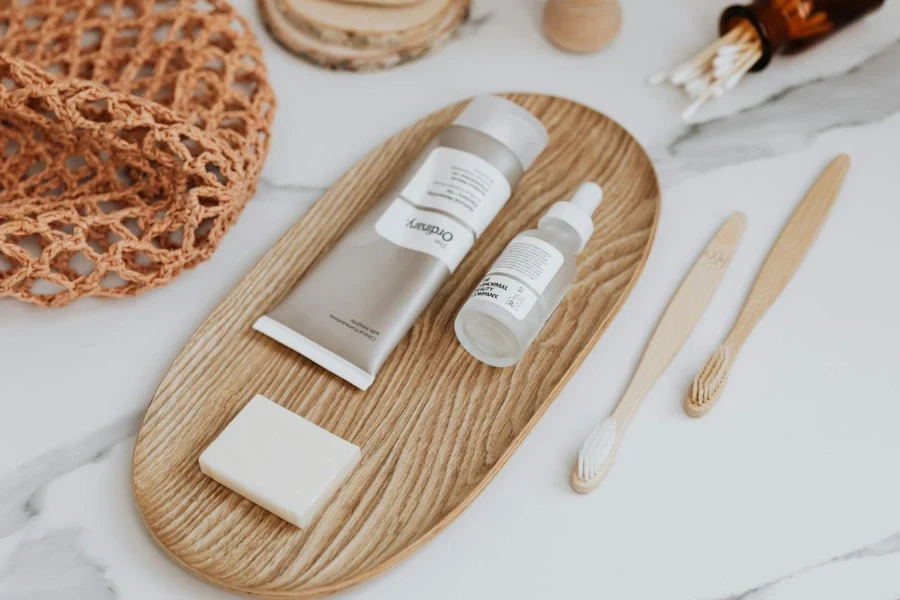 cream tube and a bottle on a wooden tray