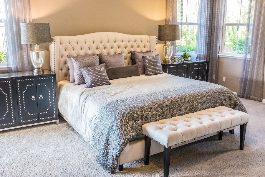 Farmhouse bedroom with beige upholstered bench