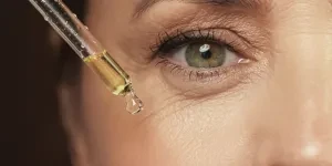 female eye and dropper with rejuvenating serum stock