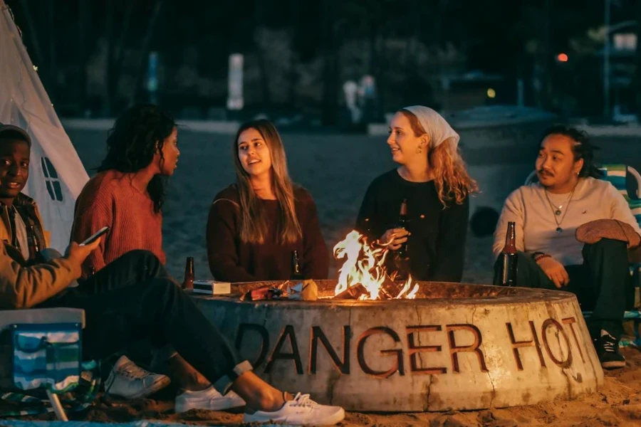 Group of friends sitting in front of fire pit