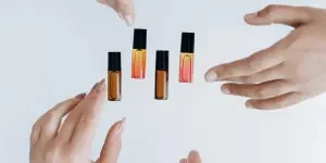 Hands surrounding multiple lip oils