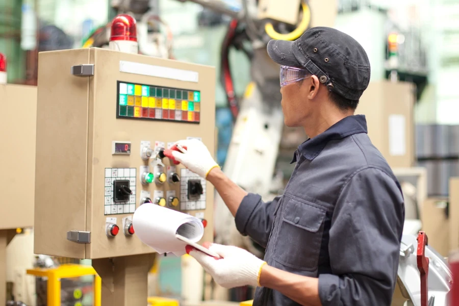 Wirtschaftsingenieur in der Fabrik, die Maschine inspiziert