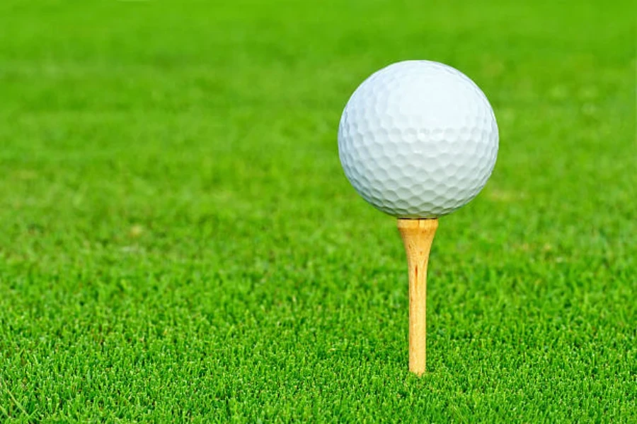 Light wooden golf tee with white golf ball on top