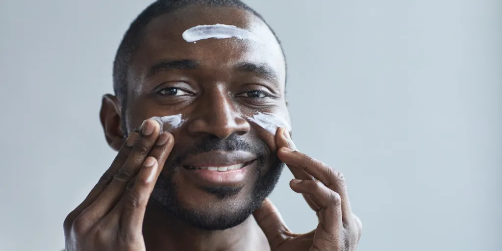 Man applying moisturizer to his face