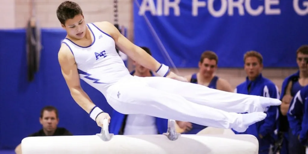 man wearing white and blue shirt jumping on vault table