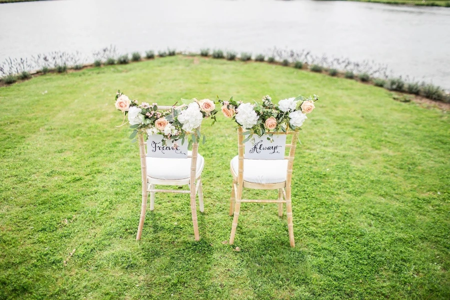 Minimalistic wedding décor of two white chairs