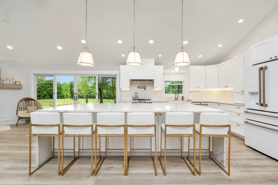 Modern white upholstered bar chairs with brass frames