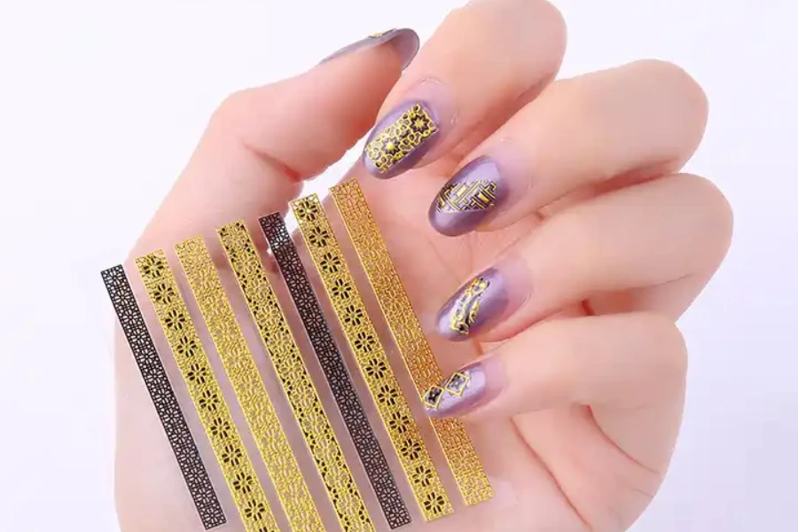 Nails with golden sequins and other metallic accents