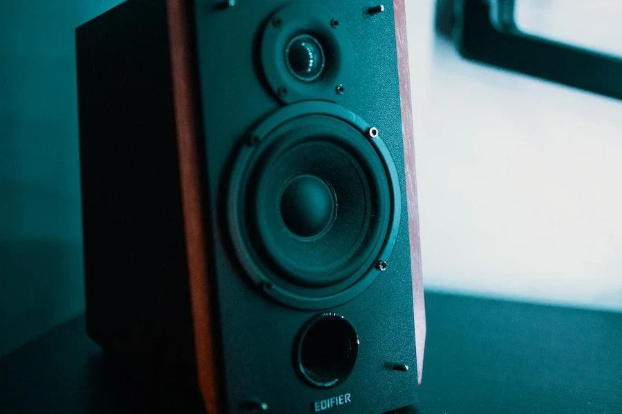 One brown and black powered speaker on a floor