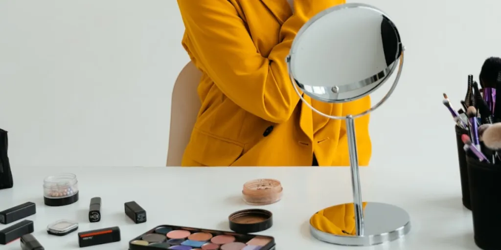 Person applying makeup in a round mirror on a stand