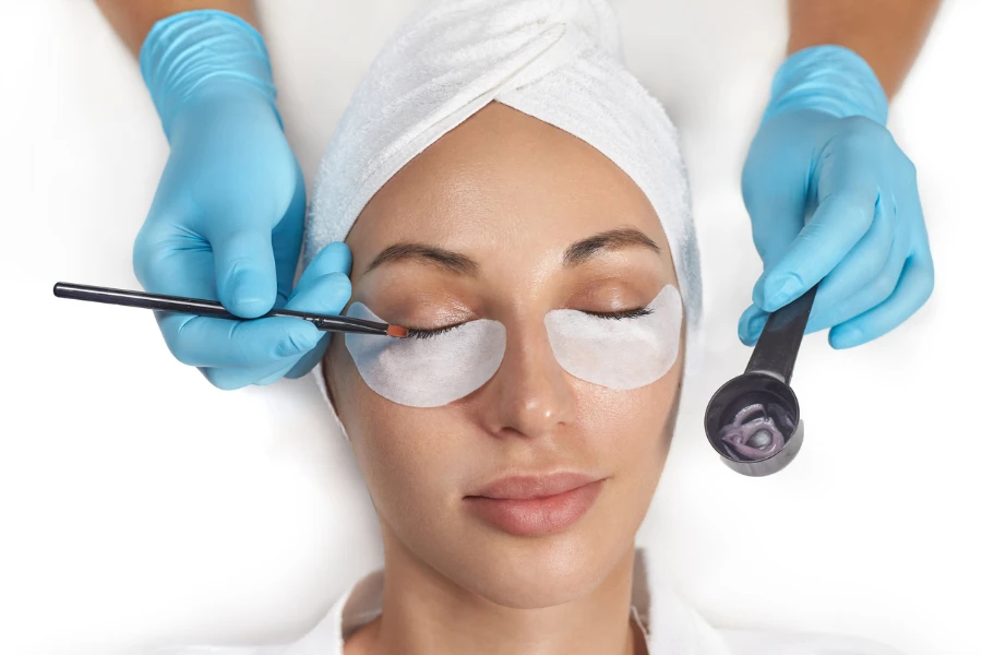 person getting a professional eyelash tint