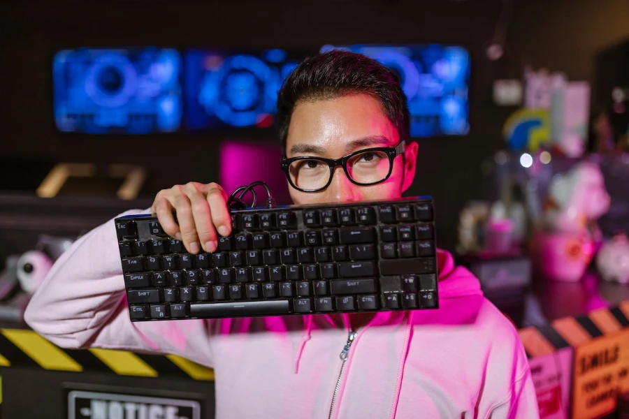 person holding up a mechanical keyboard