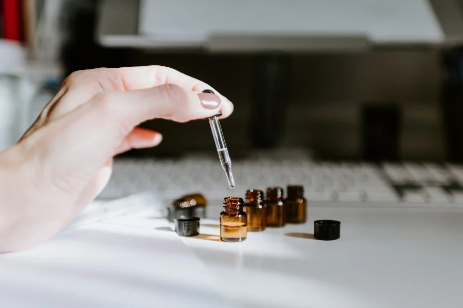 Person mixing natural skin care beauty products