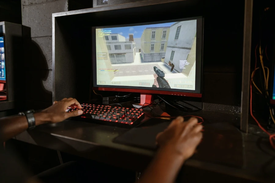 person playing a PC game using a mechanical keyboard