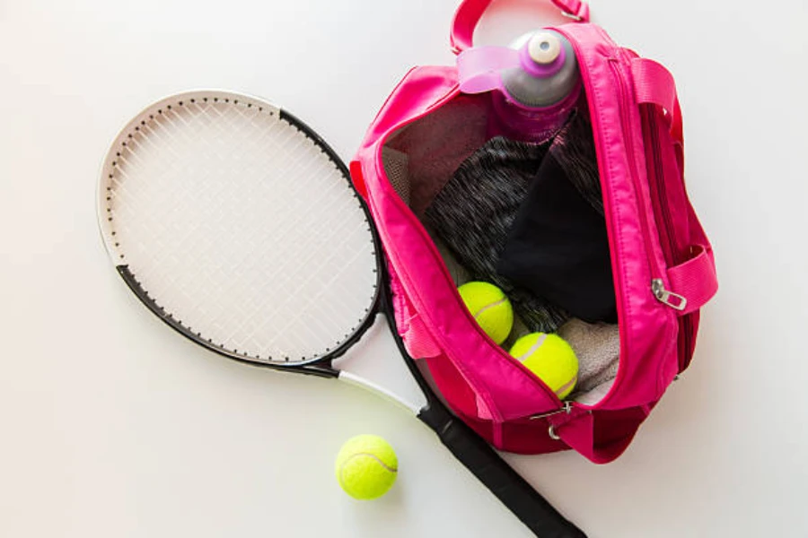 pink bag used to hold various pieces of tennis equipment